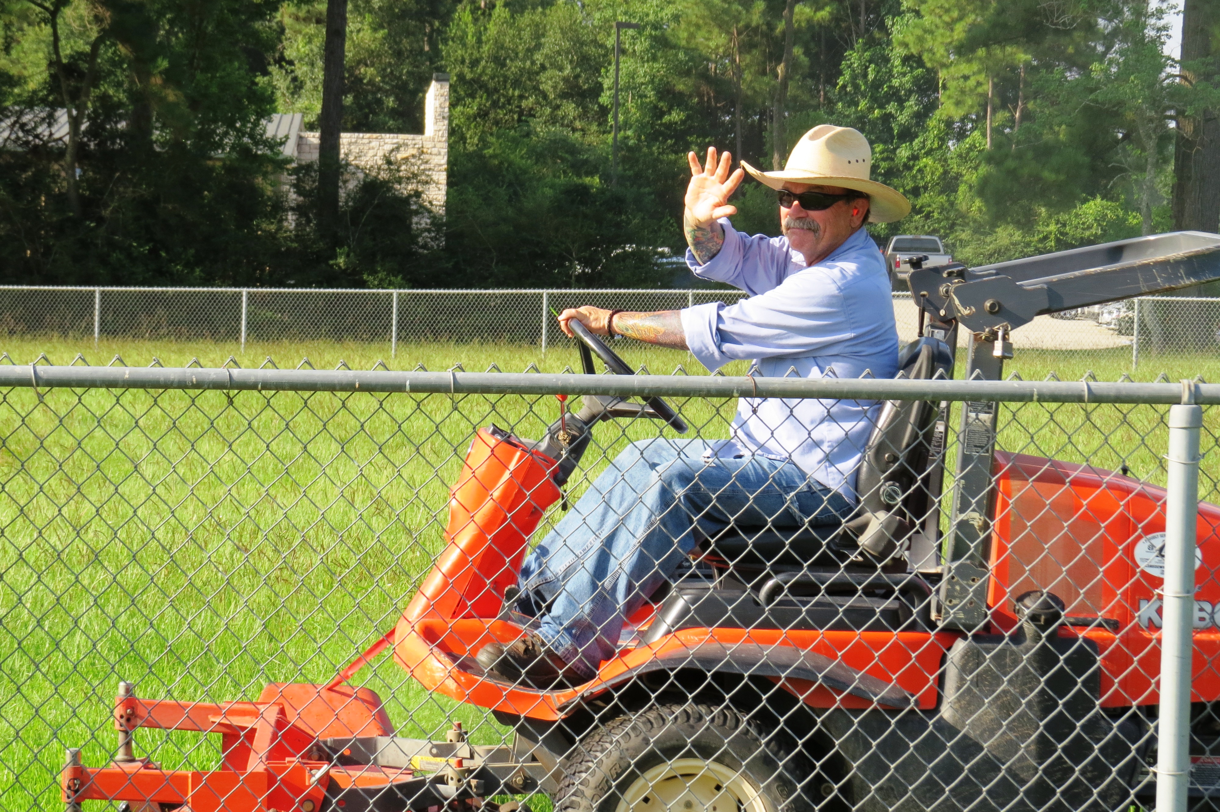 Man mowing field on riding mower