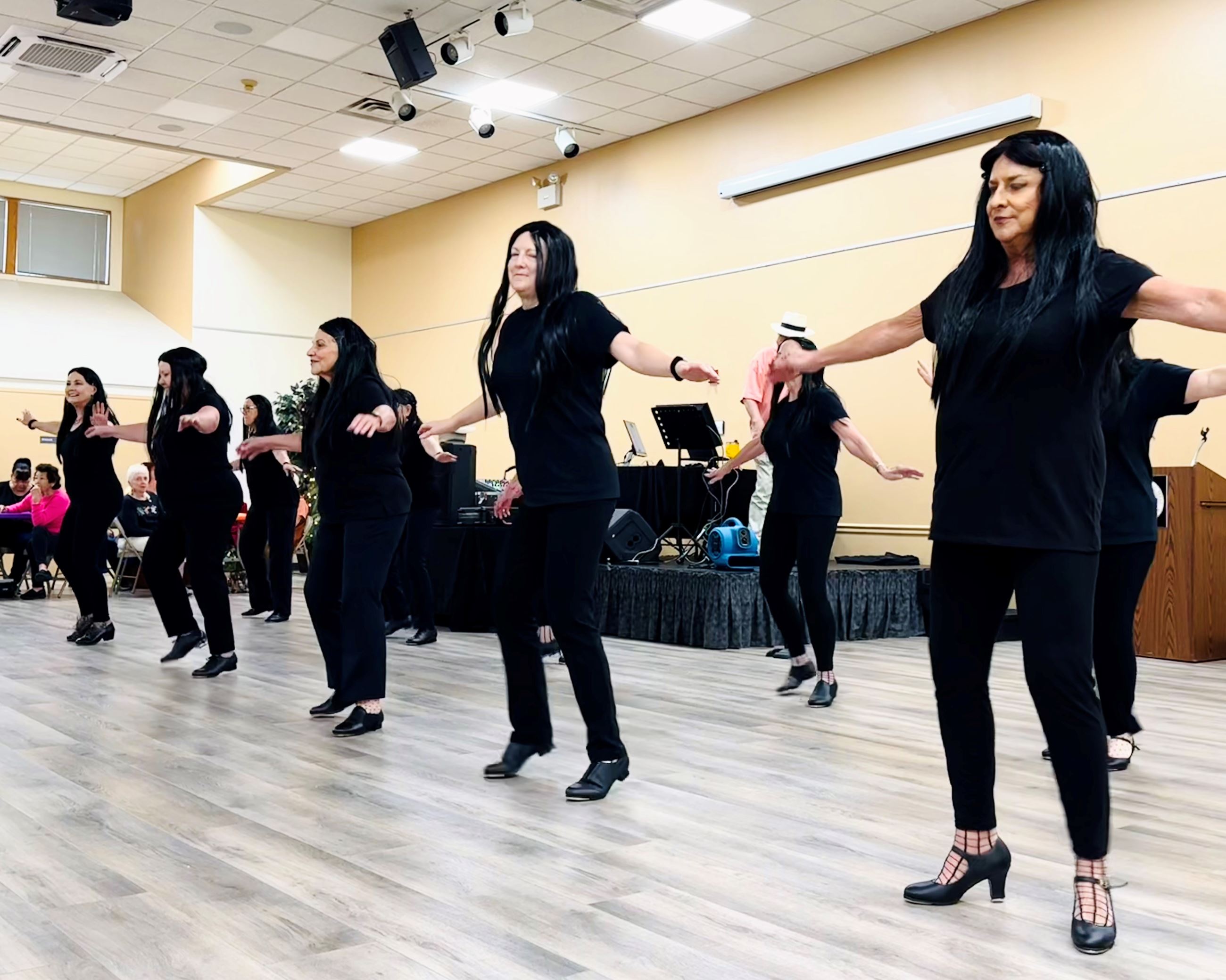 pic of ladies tap dancing in black costumes 