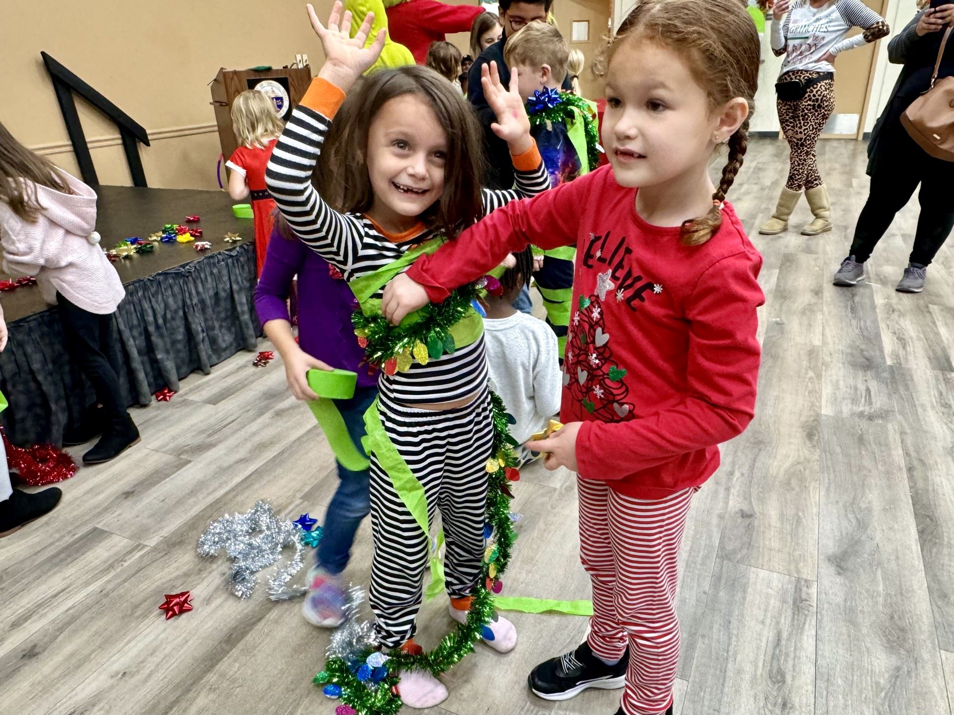 kids wrapping each other as Christmas tree