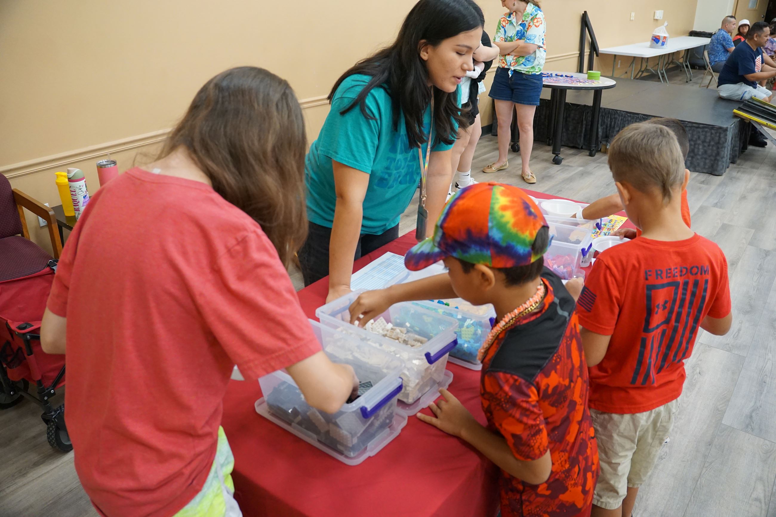 Image of July 2025 Tomball Kids Club participants selecting LEGOs for their vehicles
