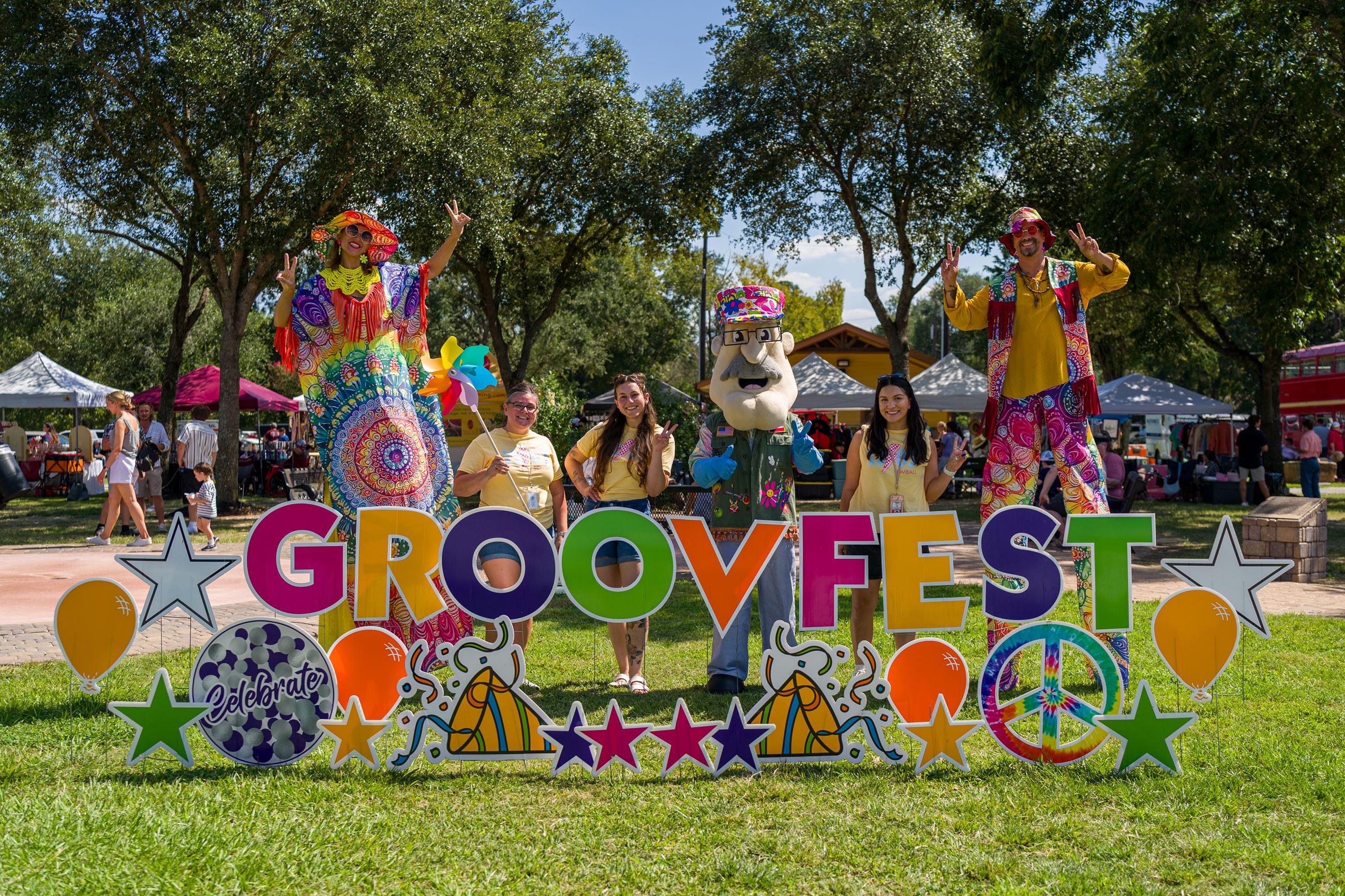 Image of Groovfest Sign with Marketing Team