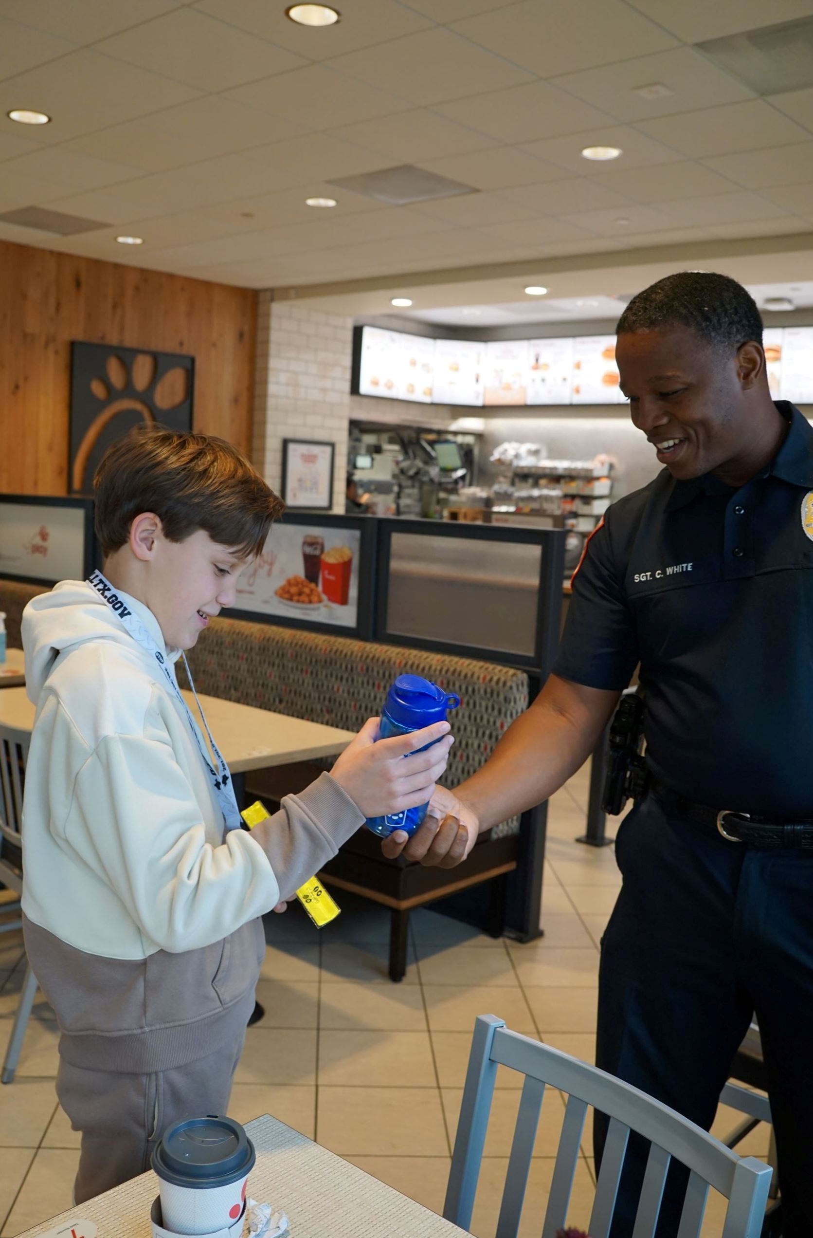 Image of Tomball Police Department Officer with Child at February 2026 Coffee with a Cop